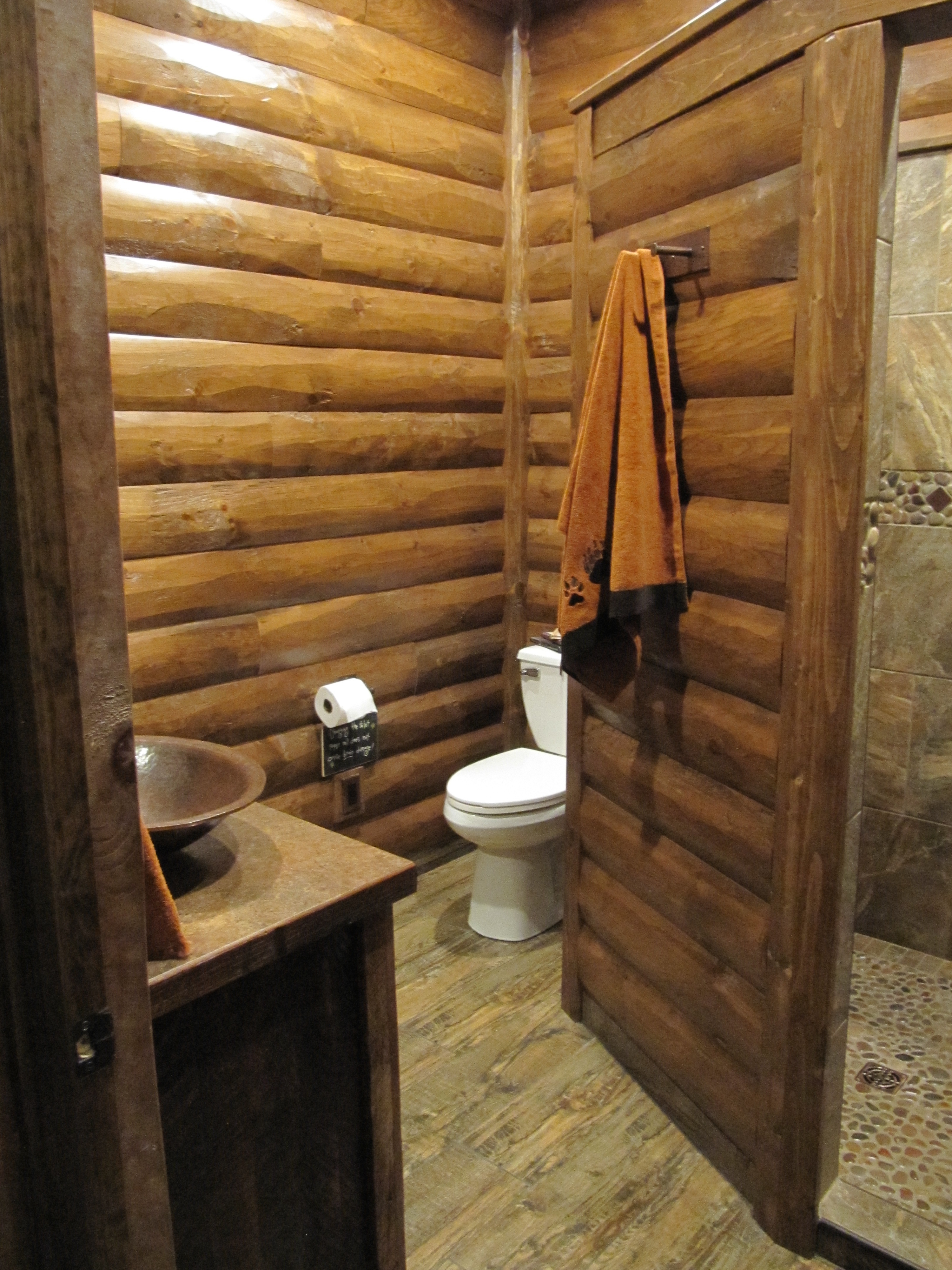Bathroom with 2x8 pine log siding with pine D-trim, prestained chestnut.
